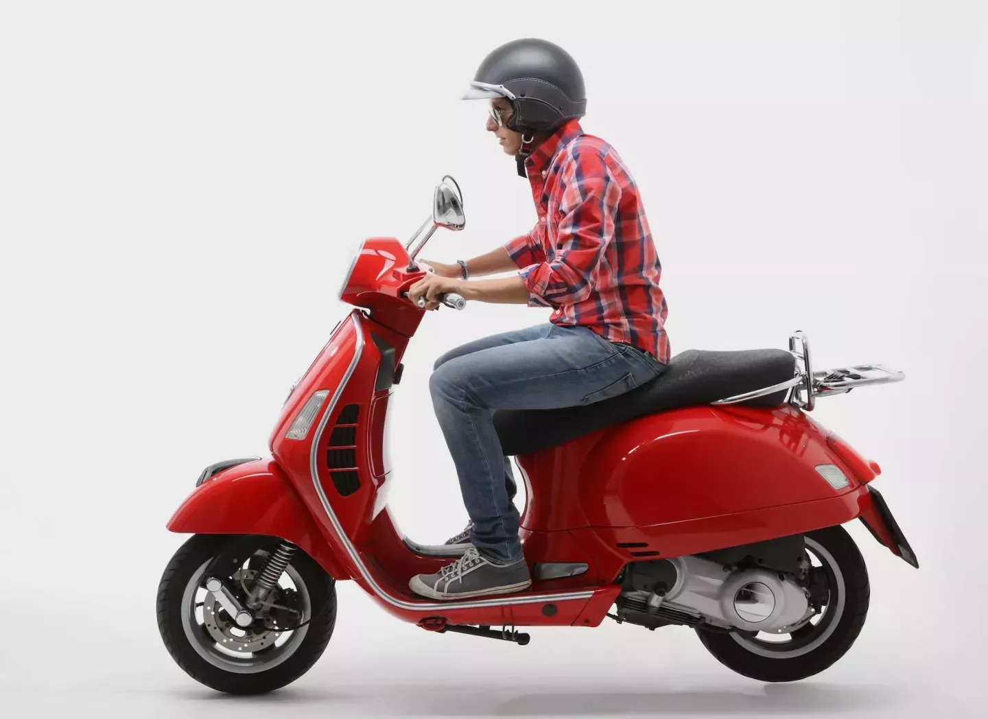 Man riding a red scooter Man riding a red scooter