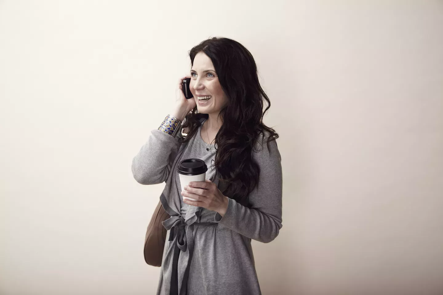 talking on phone holding coffee talking on phone holding coffee