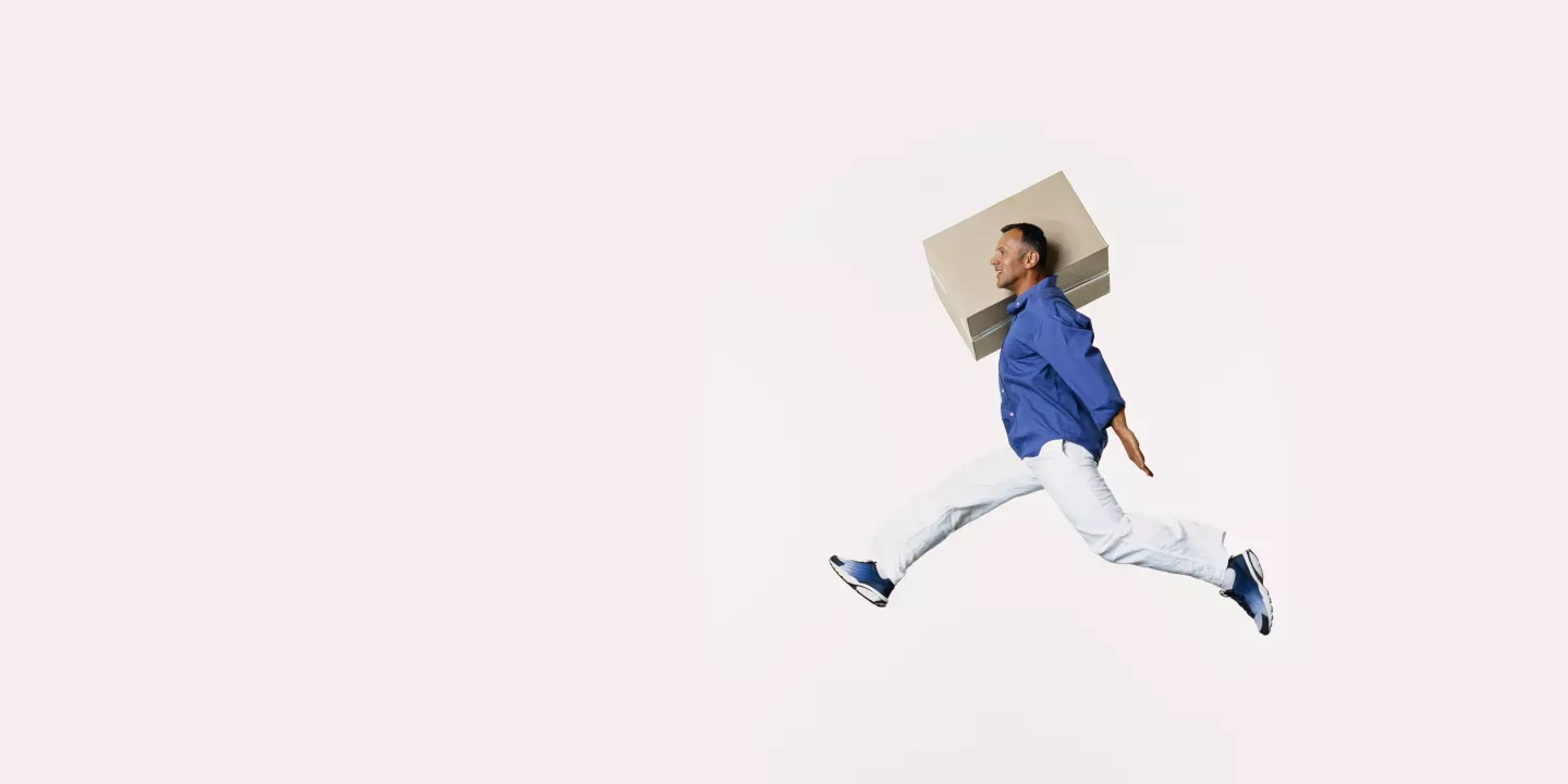 Man jumping with a box Man jumping with a box