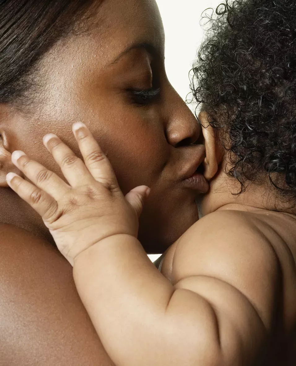 Mother kissing her baby Mother kissing her baby
