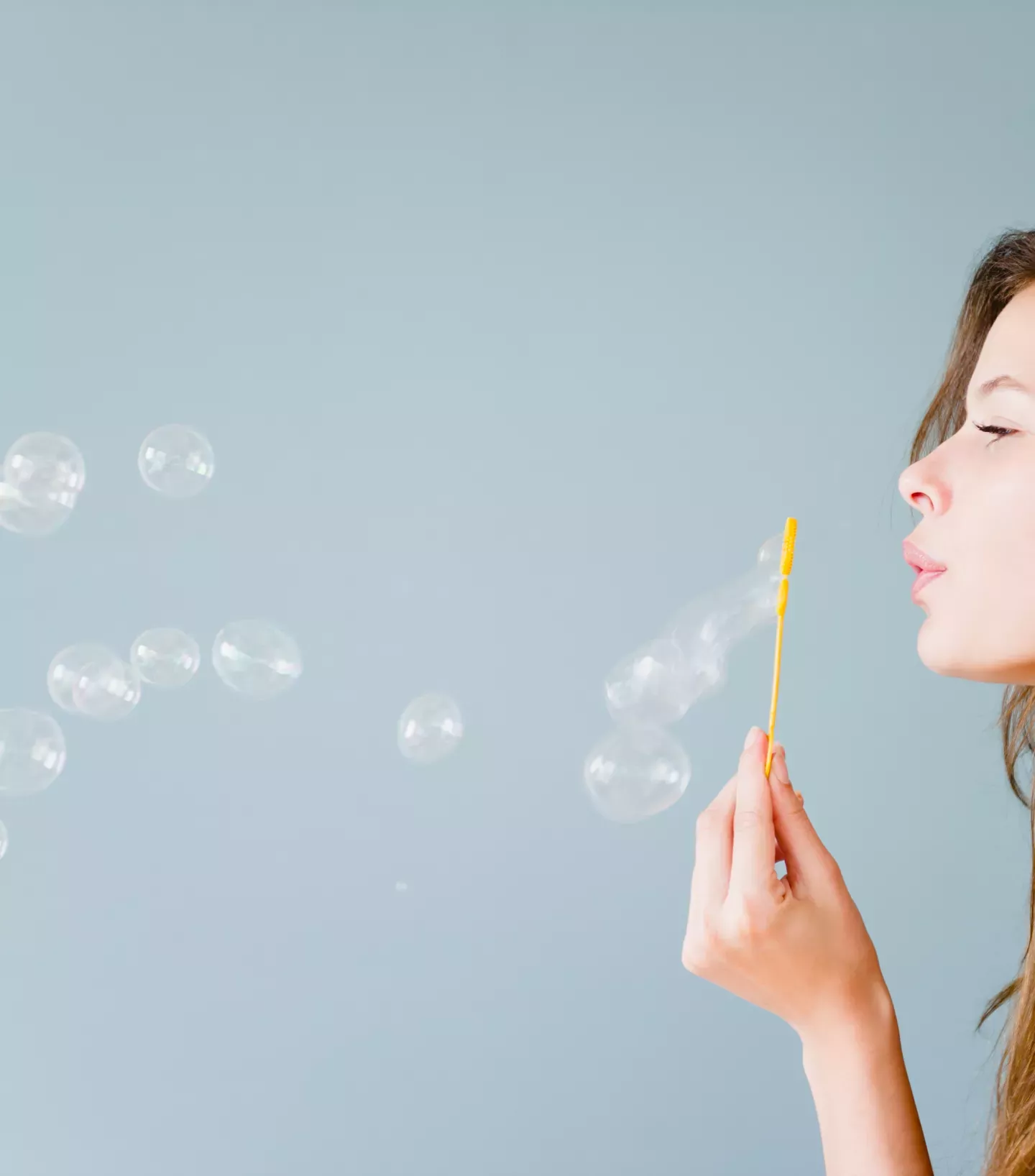 Woman blowing bubbles Woman blowing bubbles