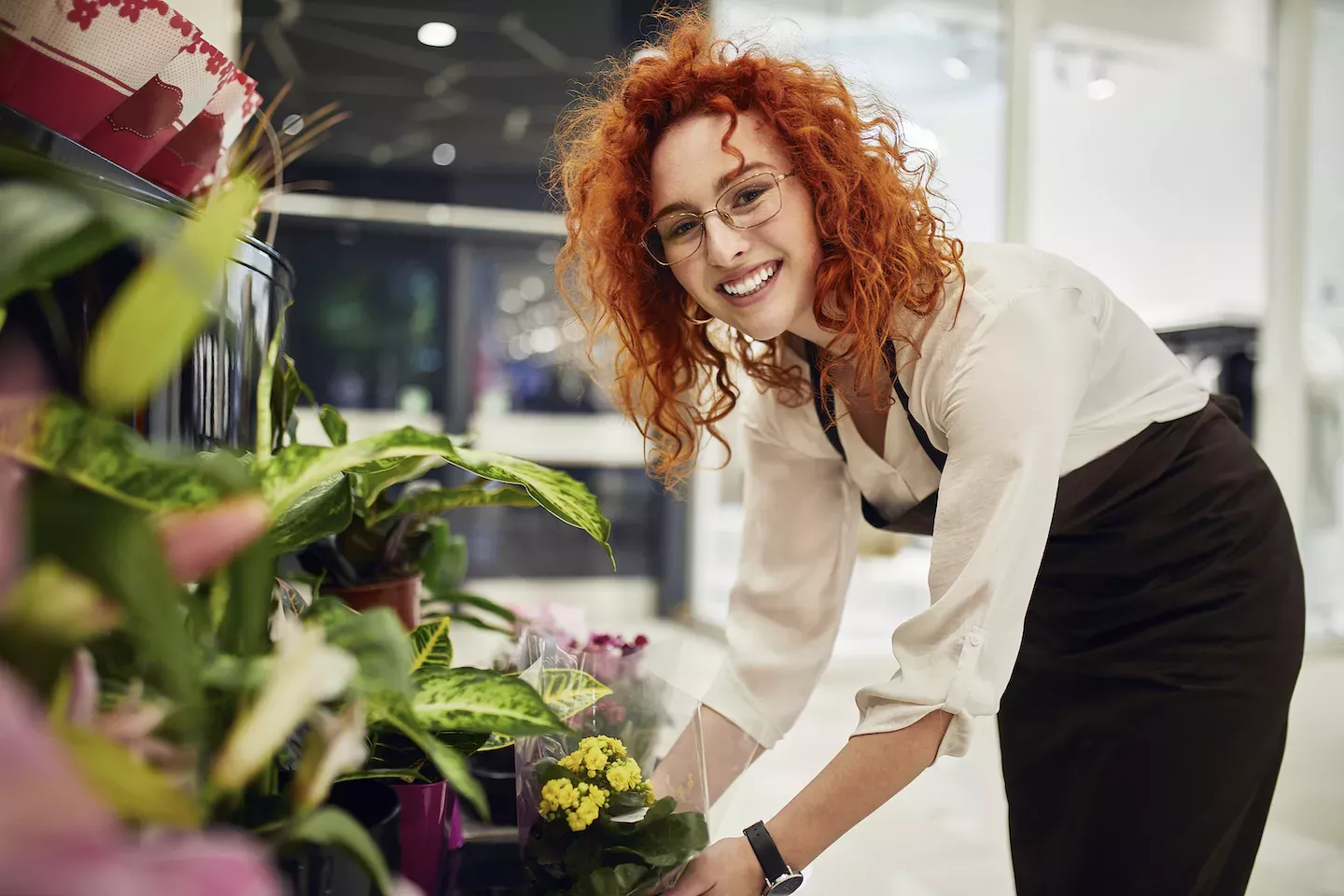 Florist smiling and arranging flowers Florist smiling and arranging flowers