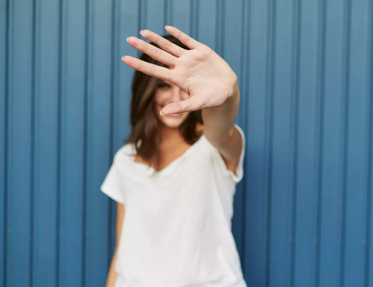 Woman covering face with her hand Woman covering face with her hand