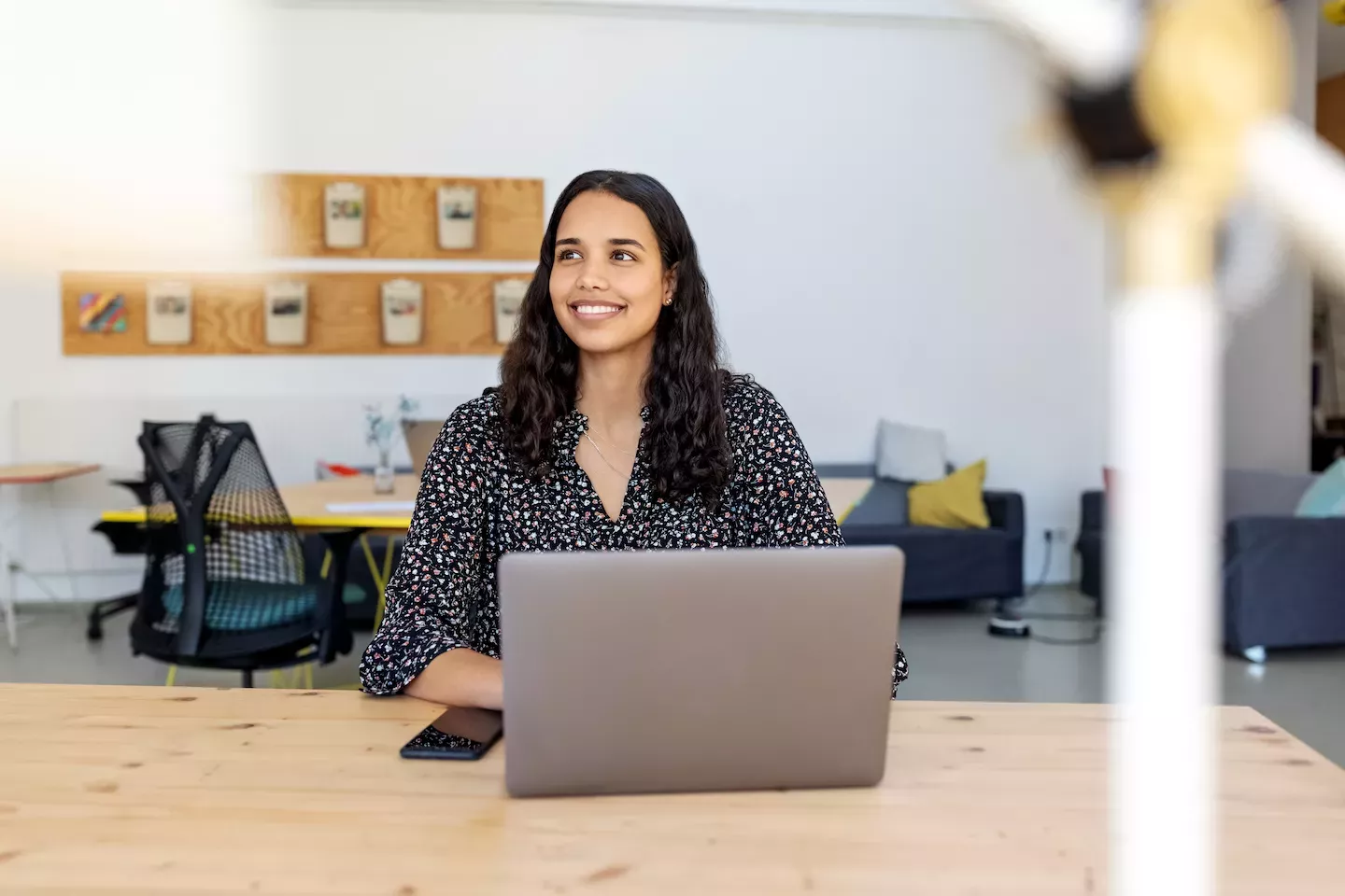 Woman smiling and holding a laptop Woman smiling and holding a laptop