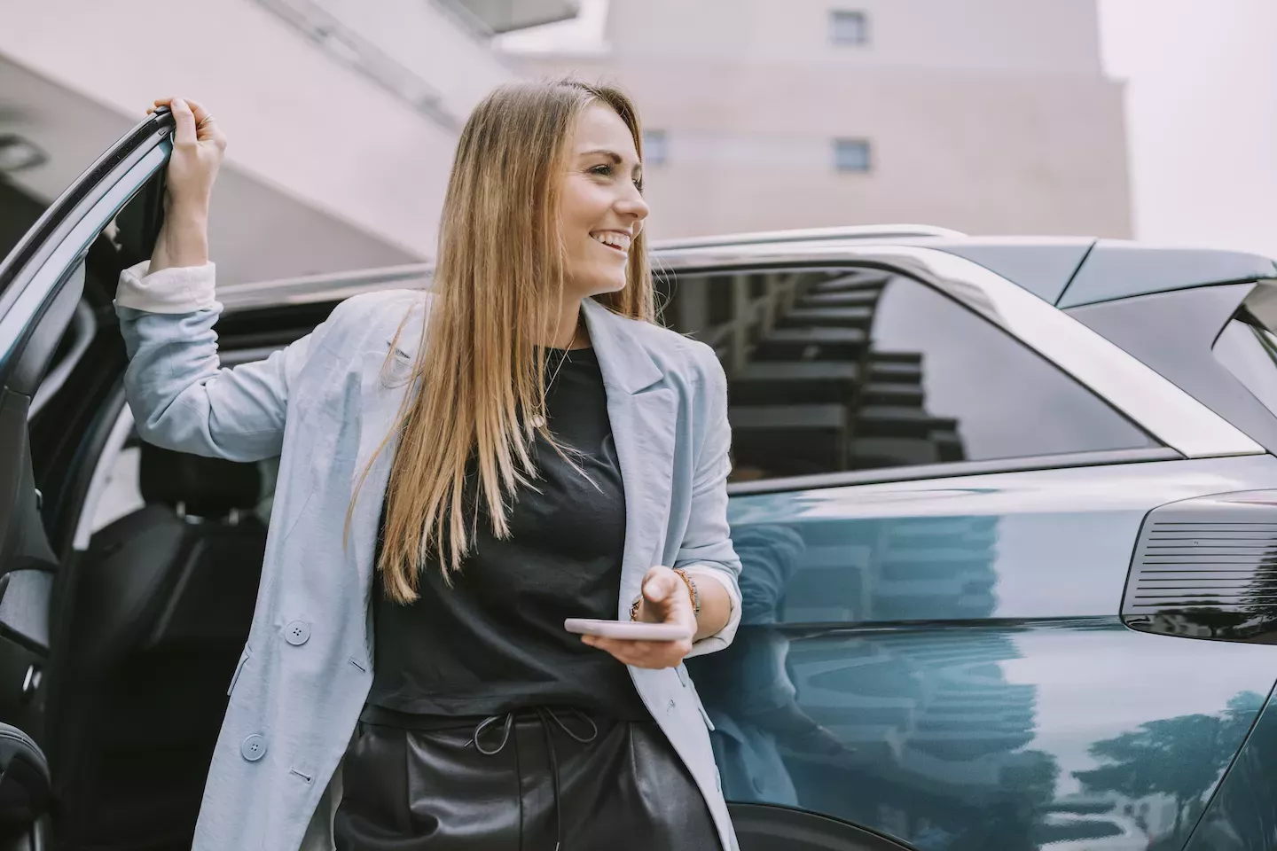 Woman opening a car door Woman opening a car door