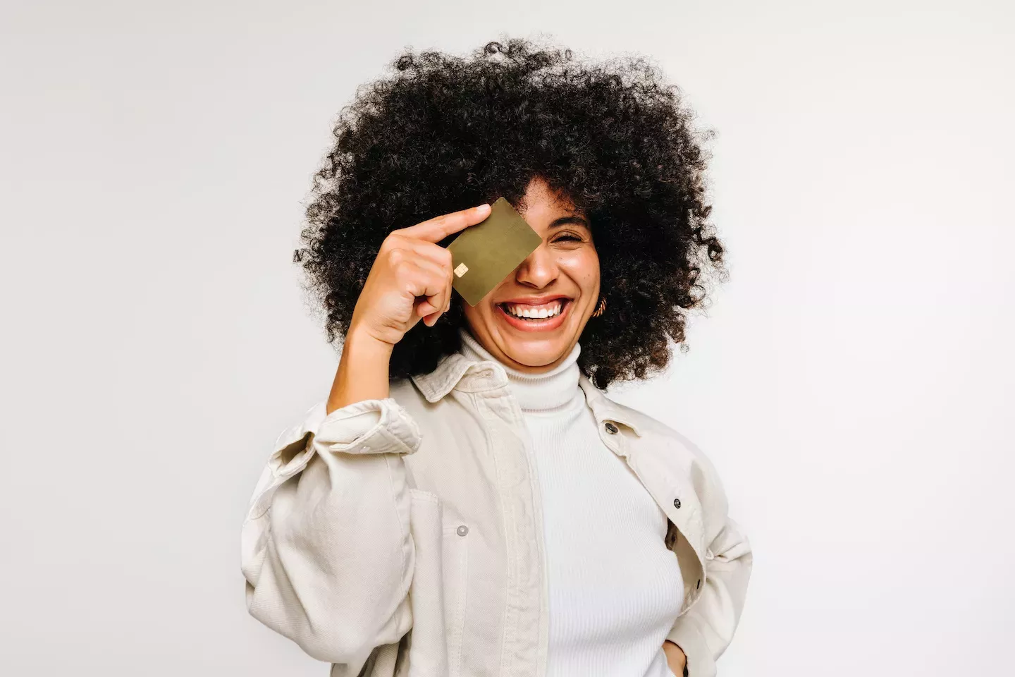 Woman holding a credit card over her eye Woman holding a credit card over her eye