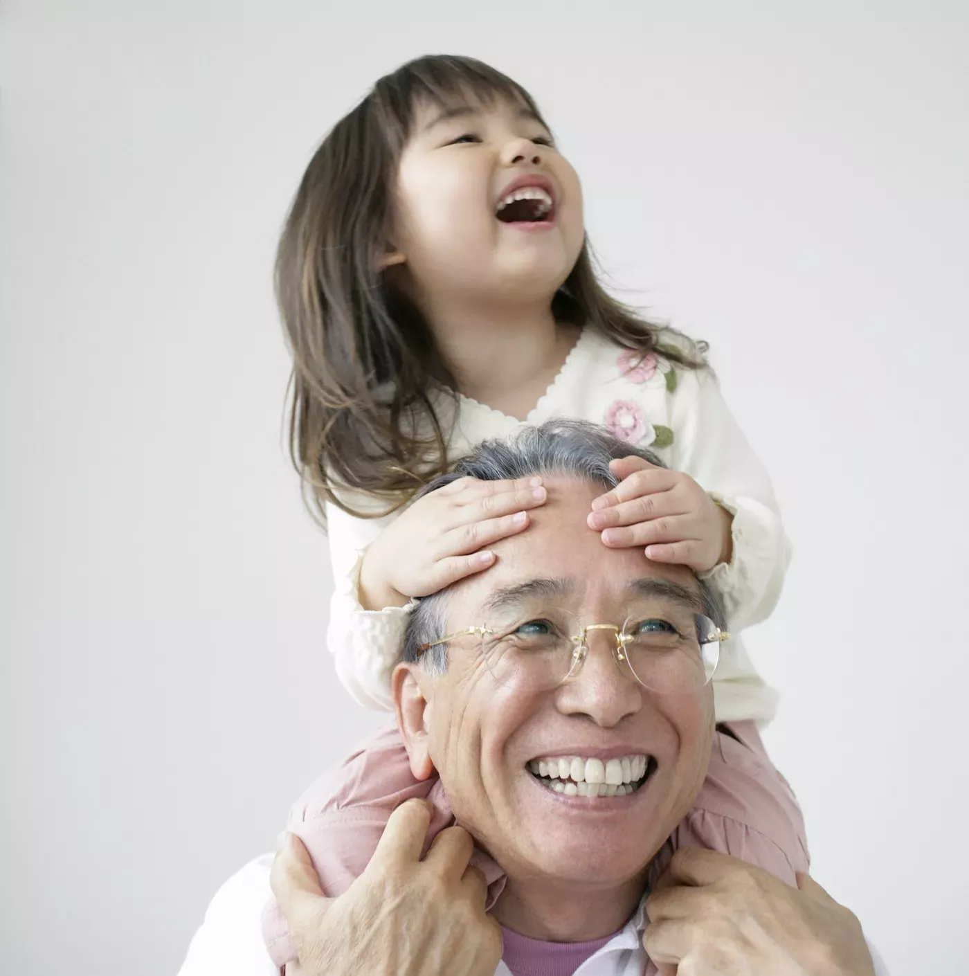 Grandfather with granddaughter on his shoulders Grandfather with granddaughter on his shoulders