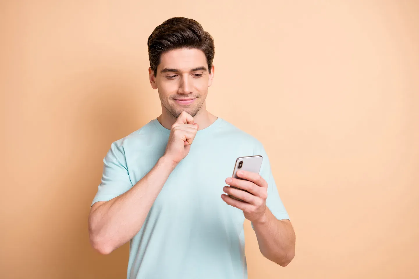 man looking at cell phone with questionable expression man looking at cell phone with questionable expression