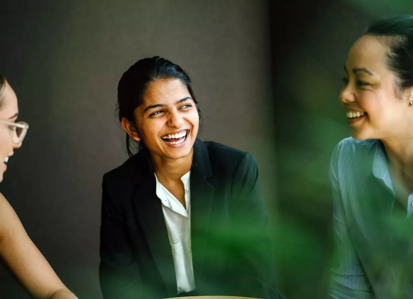 three people talking and laughing three people talking and laughing