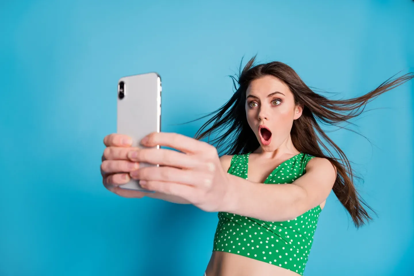 Surprised young woman with phone Surprised young woman with phone