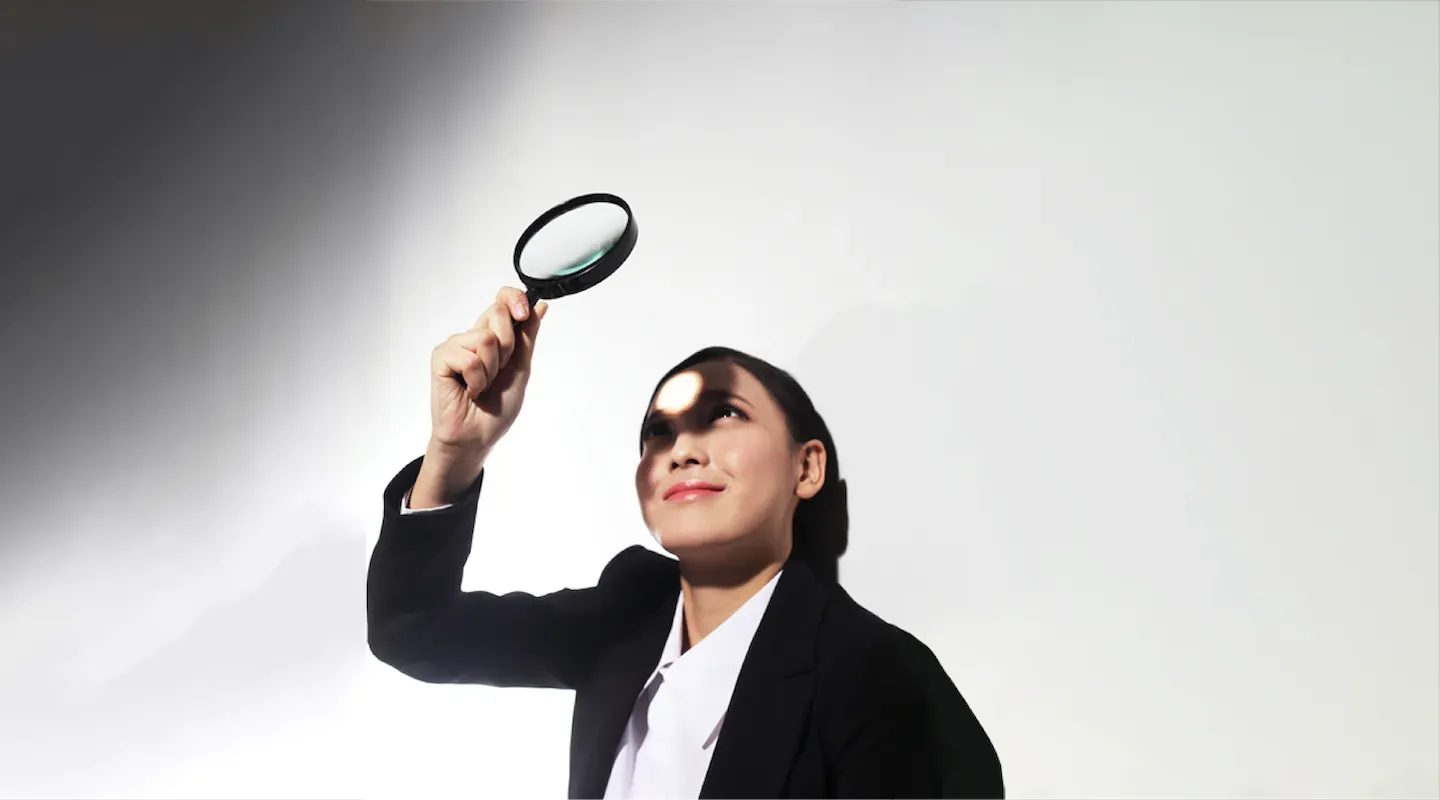 Woman looking through magnifying glass Woman looking through magnifying glass