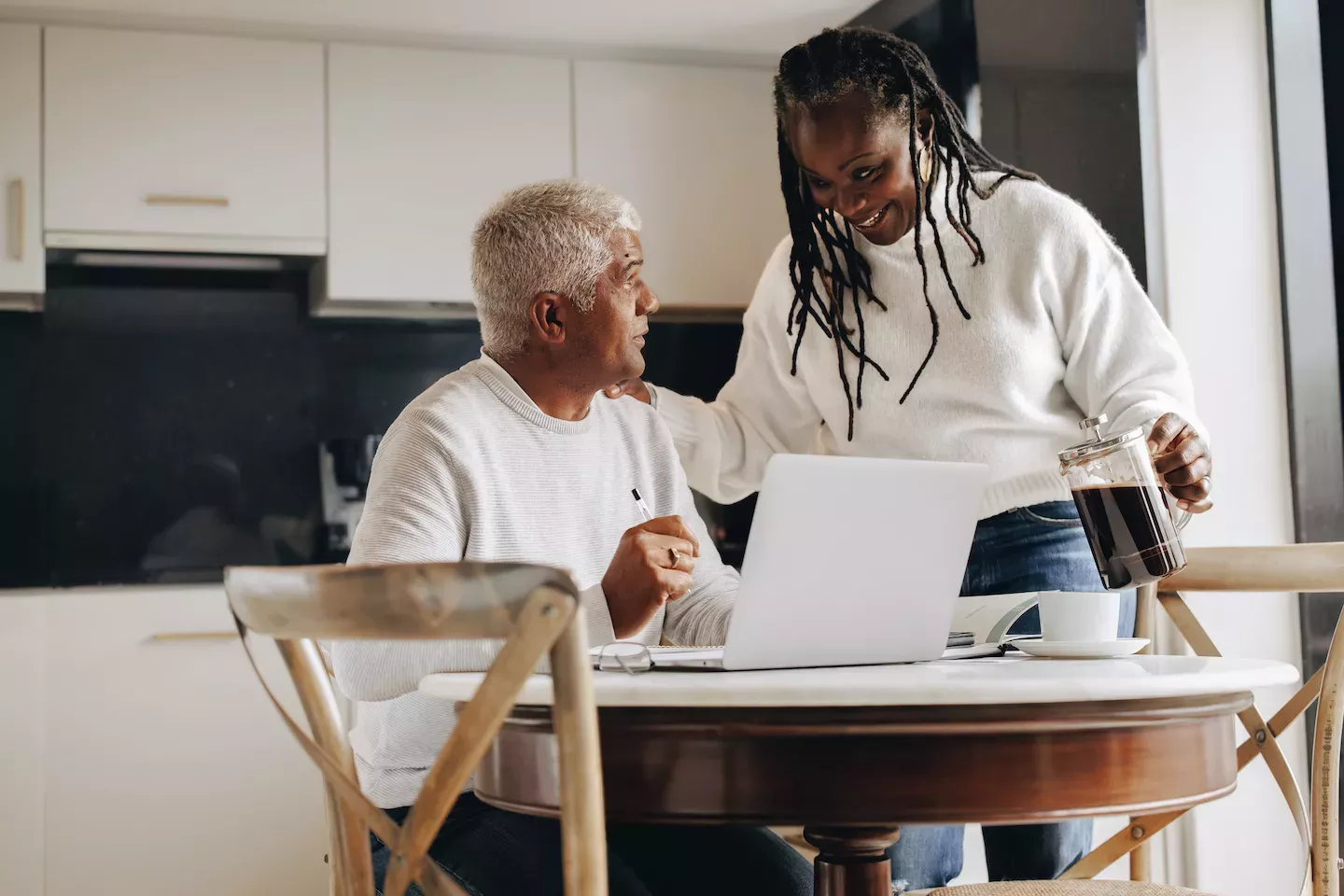 Couple paying bills in the kitchen Couple paying bills in the kitchen