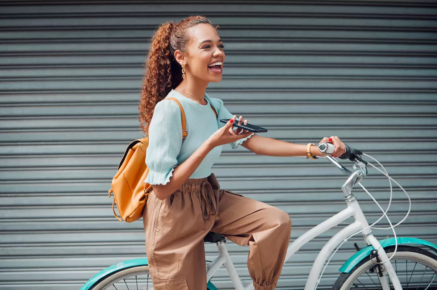 Woman talking on the phone while riding a bike Woman talking on the phone while riding a bike