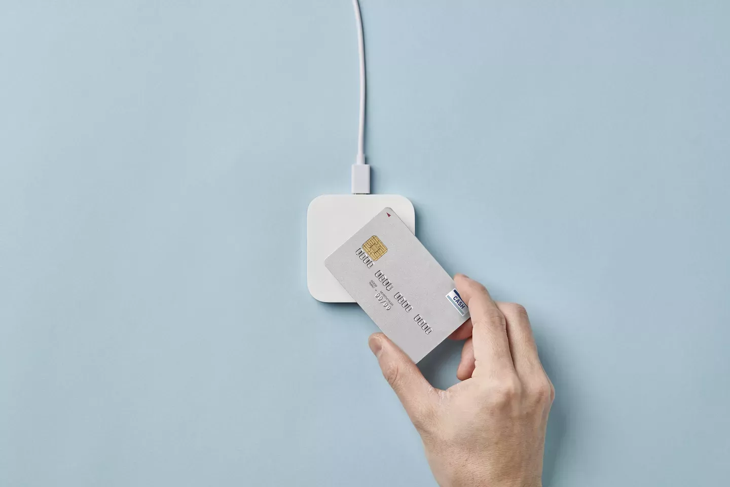 Person paying with a debit card Person paying with a debit card