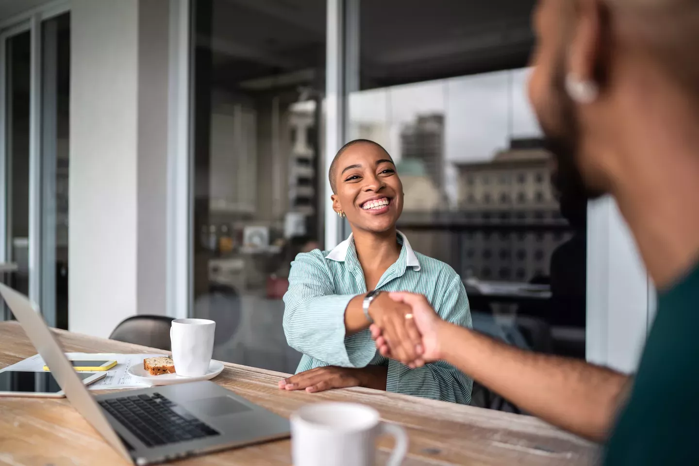 Woman shaking hands with a customer Woman shaking hands with a customer