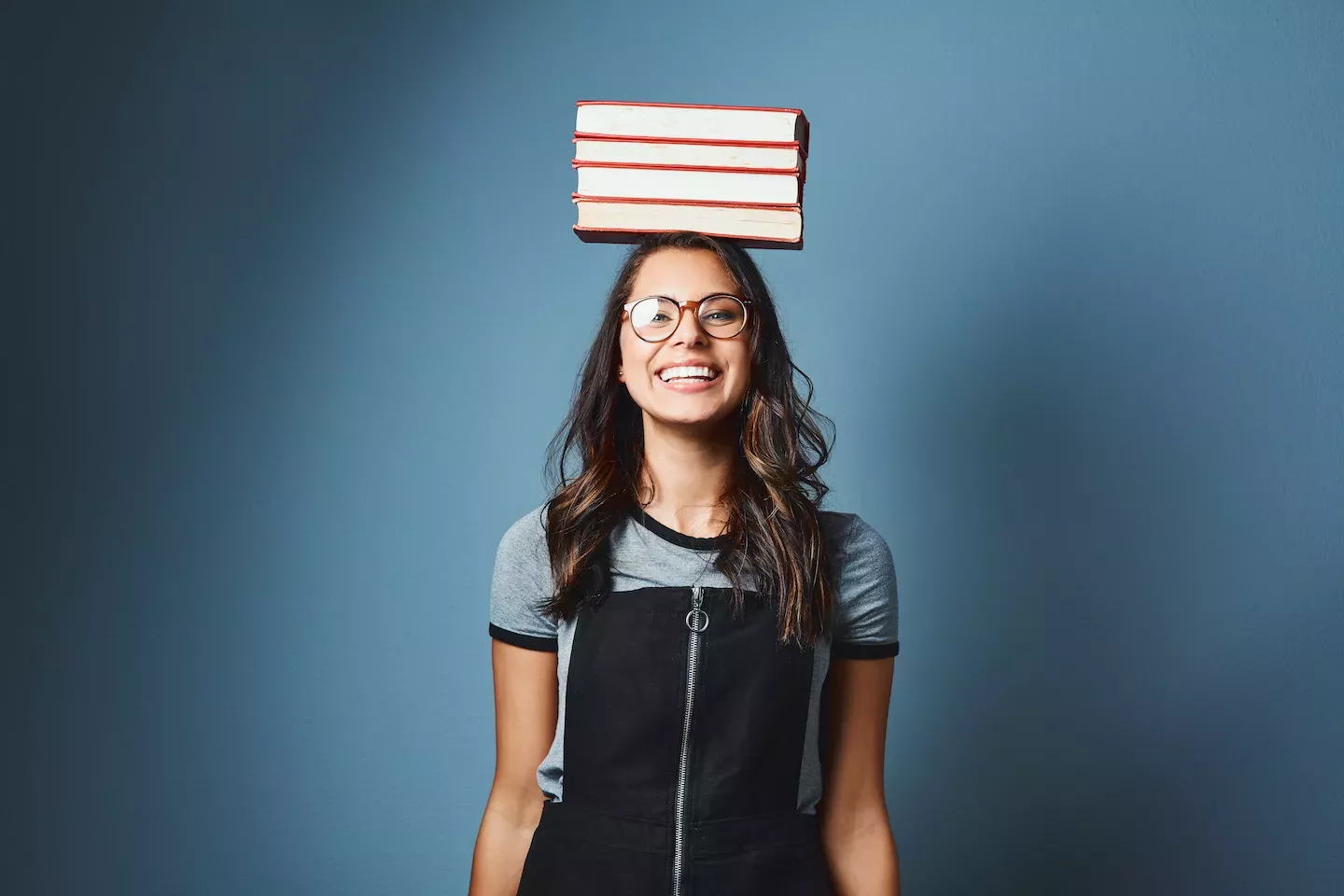 Woman balancing books on her head Woman balancing books on her head
