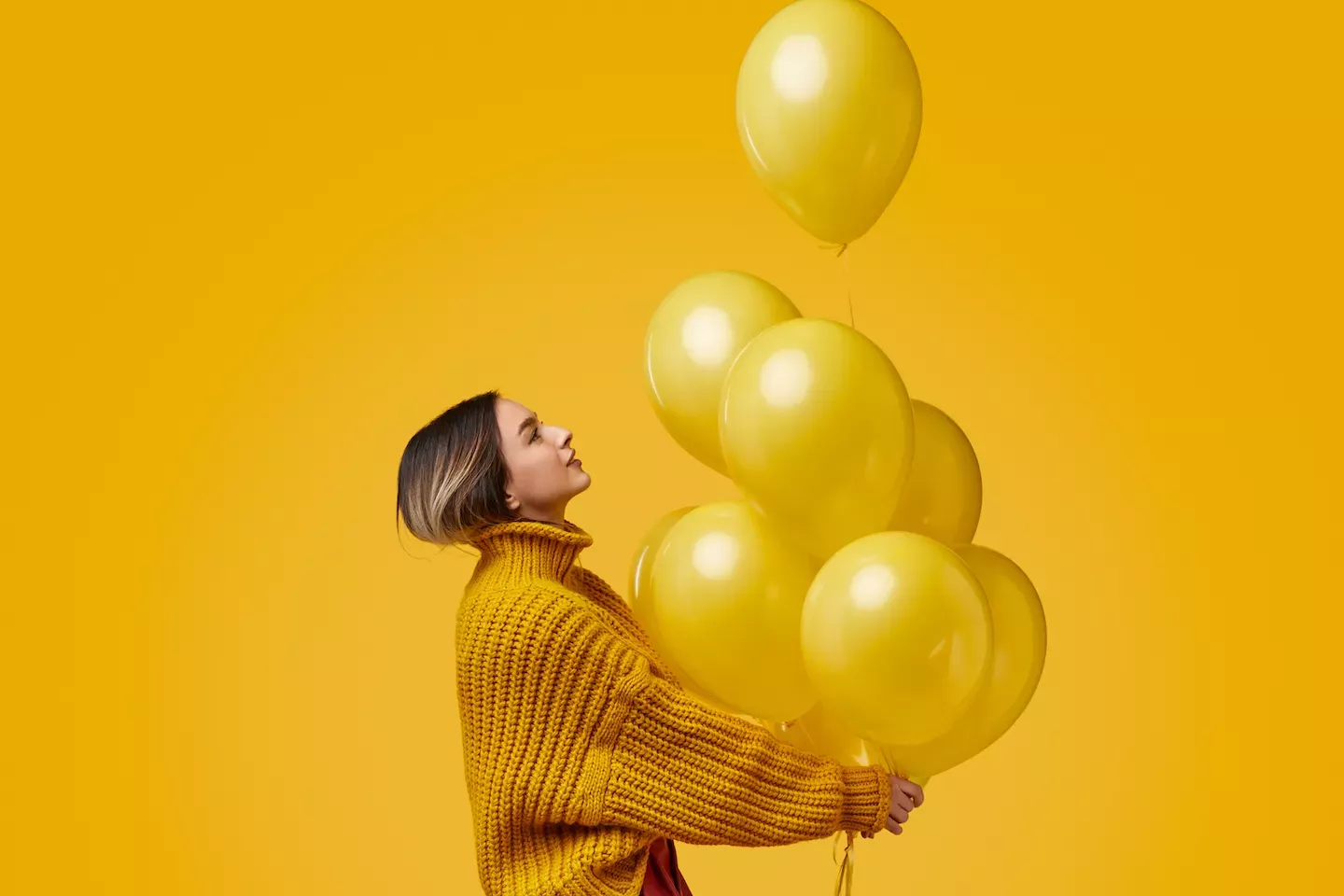 Woman holding balloons Woman holding balloons