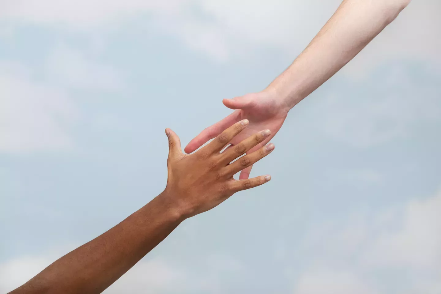 People reaching out to grab hands People reaching out to grab hands