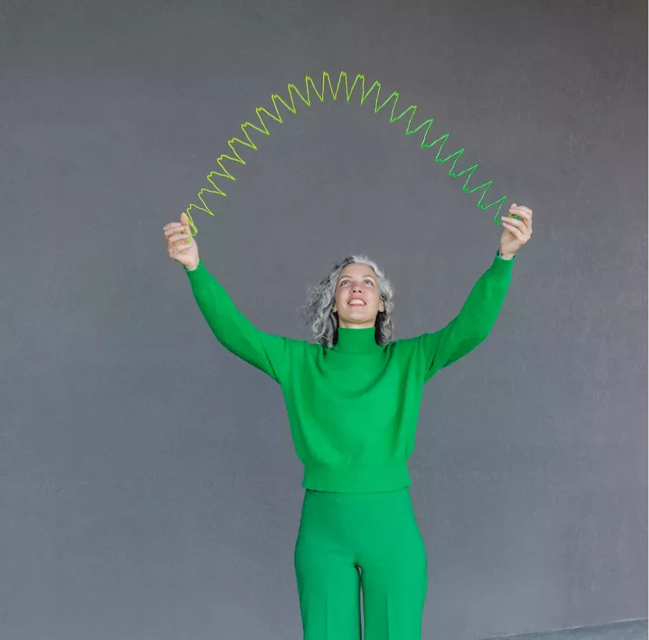 Woman playing with a slinky Woman playing with a slinky