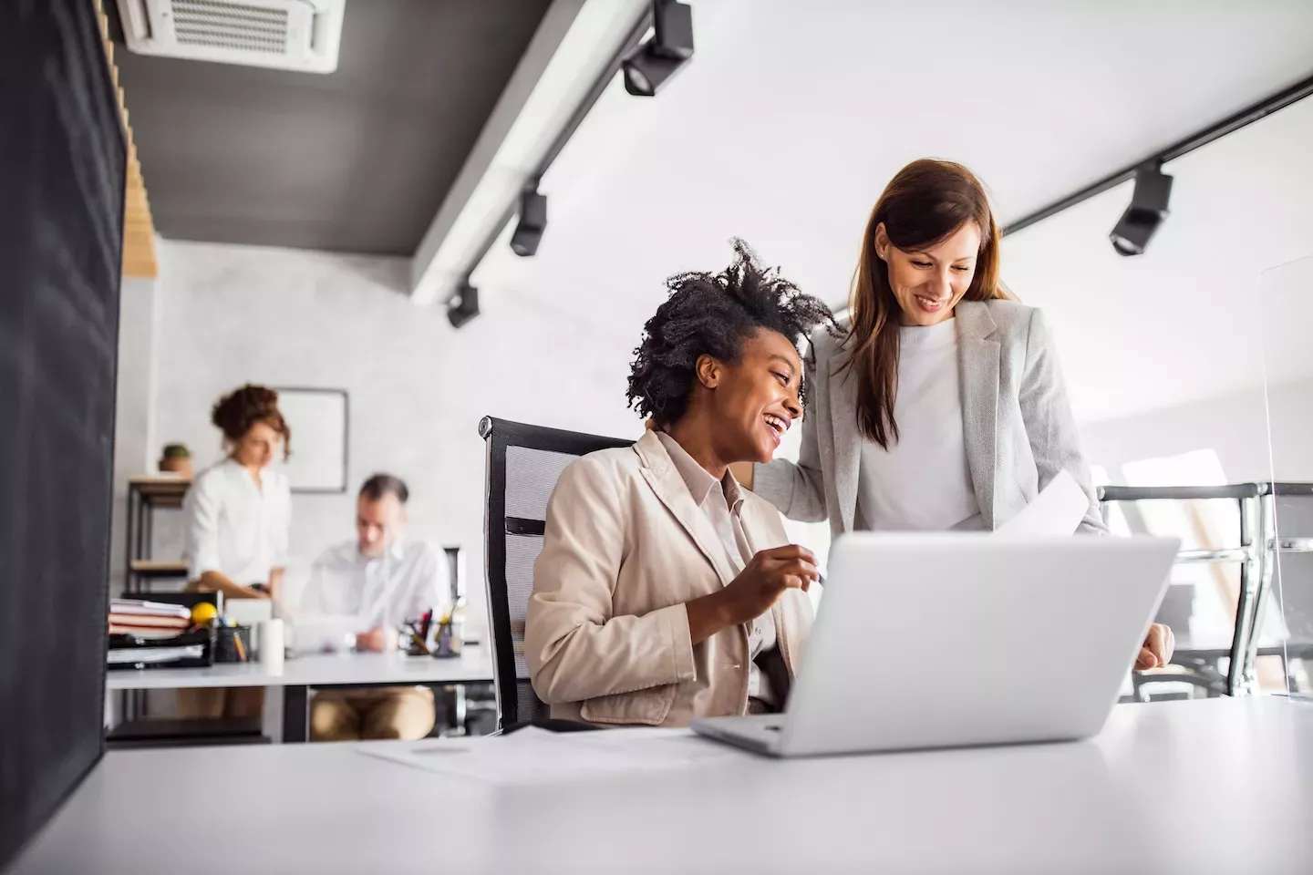 Two people looking at a laptop Two people looking at a laptop