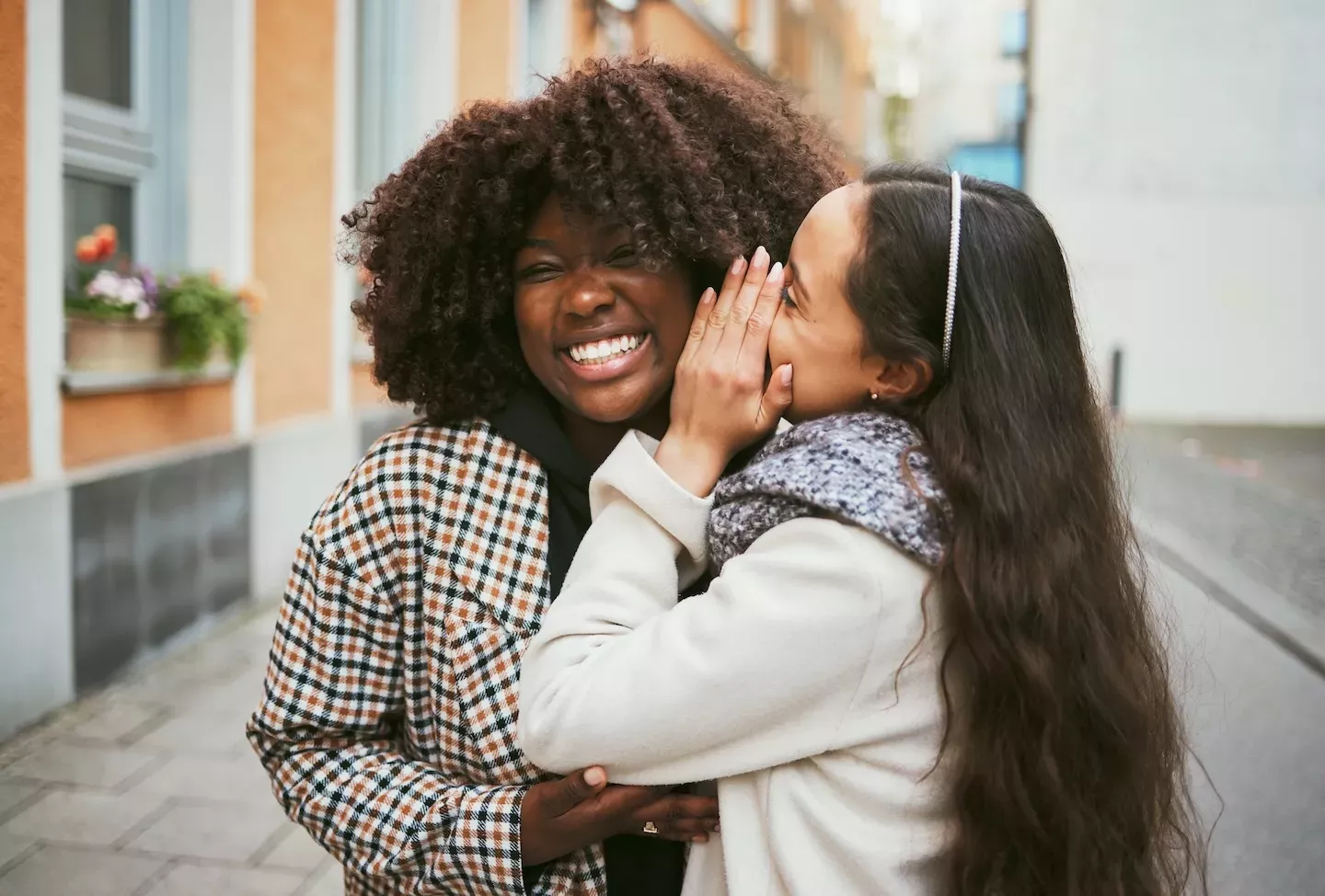 person whispering into another person's ear person whispering into another person's ear