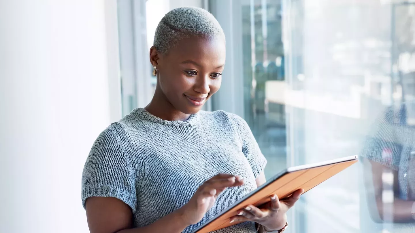 Person looking at tablet Person looking at tablet