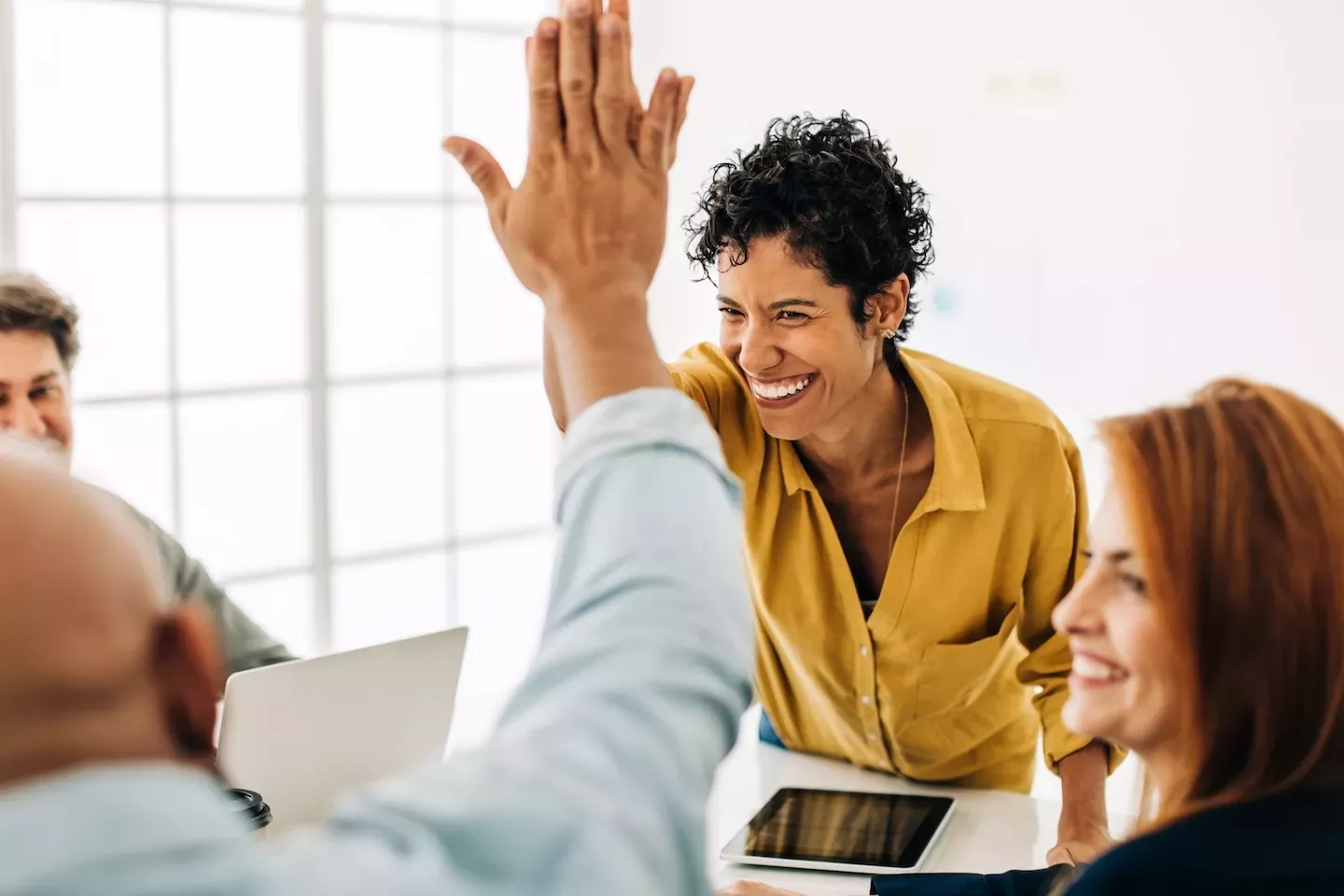 two people high fiving two people high fiving