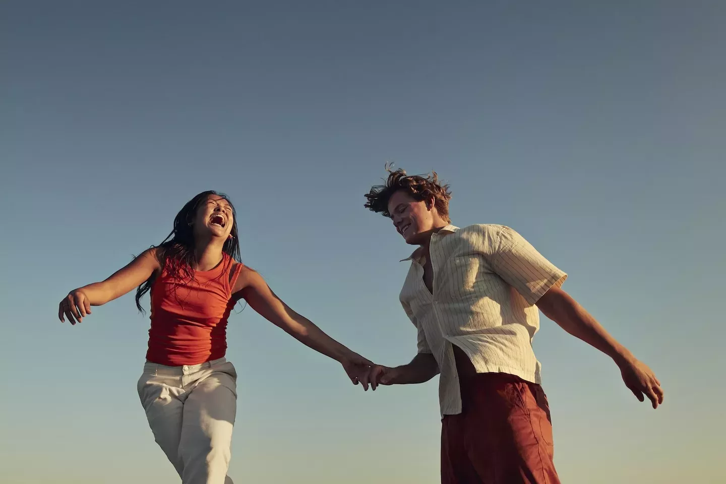 two happy people holding hands two happy people holding hands