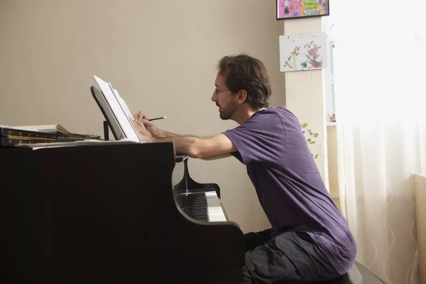 person composing a song on the pianno person composing a song on the pianno